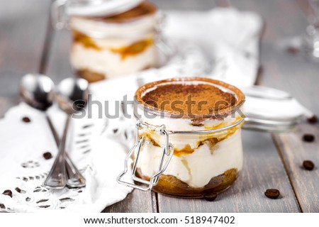 dessert tiramisu in a jar with sea-buckthorn puree Royalty-Free Stock Photo #518947402