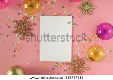 Mock up card on a pink background with their Christmas decorations and confetti. Invitation, card, paper. Place for text
