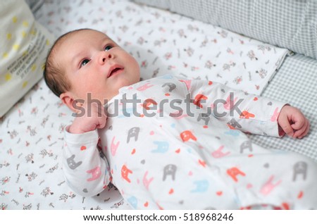 Newborn cute baby on the couch at home/Baby in infant bed
