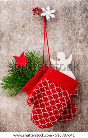 Christmas gloves on the gift card wooden background.