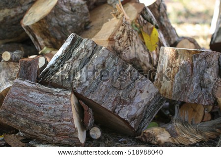 Pile of stacked firewood in rural garden ready for winter. Preparation for the winter.