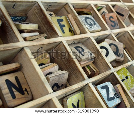 Wooden letters with numbers in a wooden tray