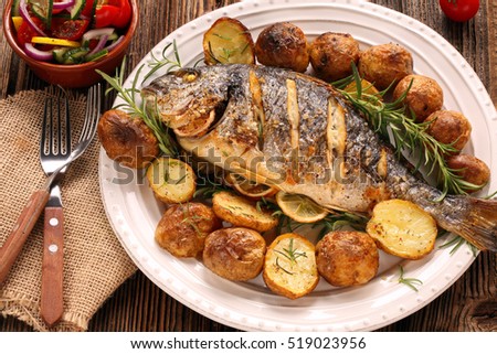 Grilled fish with roasted potatoes and vegetables on the plate


 Royalty-Free Stock Photo #519023956