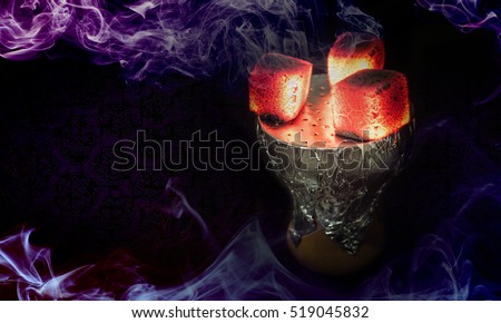 Hookah hot coals for smoking shisha and leisure in east pattern background. Bowl with tobacco and coal. Hookah wallpaper or best shisha art for web. Royalty-Free Stock Photo #519045832