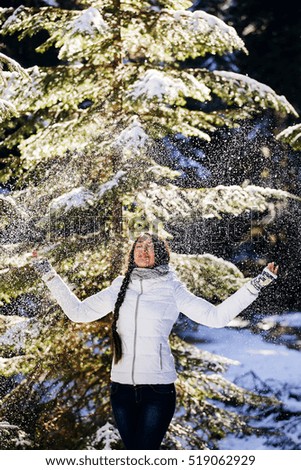 woman play with snow in forest with happy face. Winter
