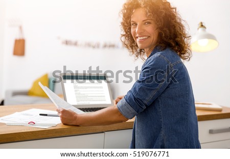 Middle age woman at the office working with a  laptop Royalty-Free Stock Photo #519076771