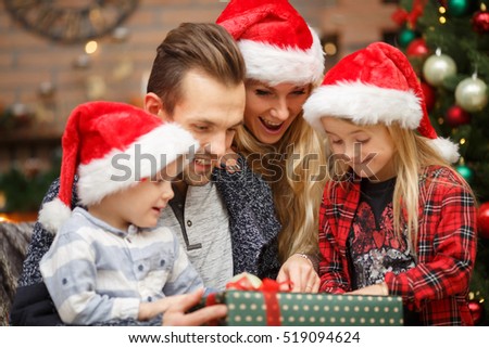 Parents with kids open gifts