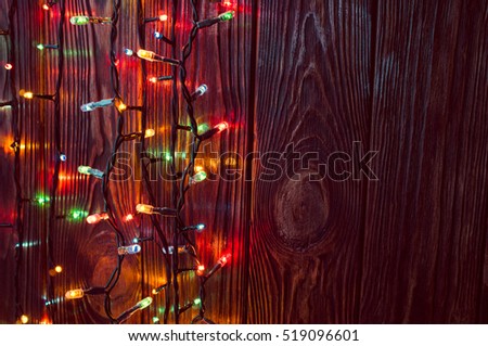 Christmas lights the night on wooden background 