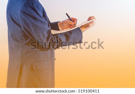 Close-up of businessman written on paper on white background / businessman is writing a letter or signing a agreement.