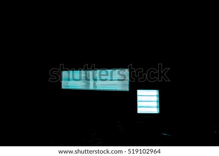 blue abstract picture of silver long horizontal lamp and square lamp against black background with gradient effect, dark grid against white light, close-up of movie illuminant against black background