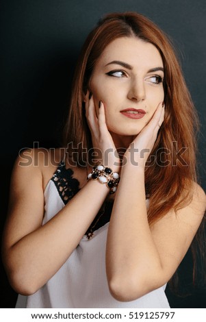 Portrait of beautiful young curly redhaired ginger girl with perfect fashion make up.
