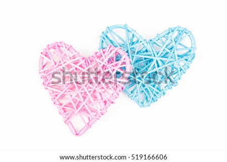 Two wicker hearts on woven wood in heart shape. Blue, pink woven Valentines day/Christmas/ Mothers day/ anniversary decorations - hearts isolated, on white background.