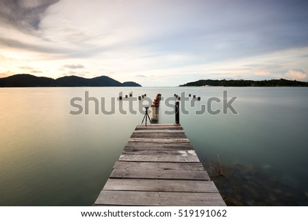 Long exposure shot of old pier at seascape. Soft focus due to long exposure shot. Composition of nature.