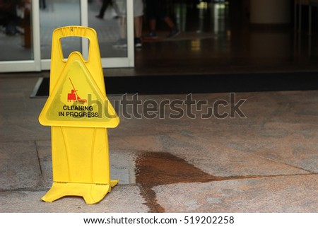 Caution Wet Floor  in front of Building Gate
