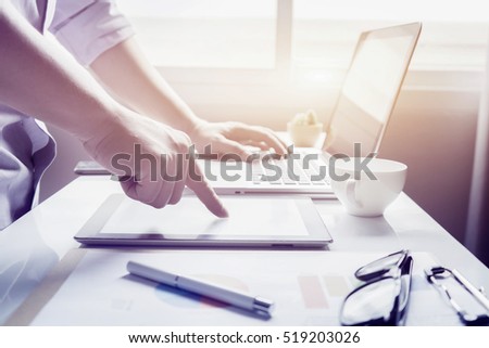 young businessmen using touchpad at meeting,He pointing at Marketing Plan,managers working with new startup project in office.Analyze document