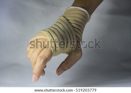 woman with wrist pain in an Elastic Bandage isolated on white background