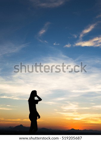 Young woman enjoying outdoors, sky background,sunset