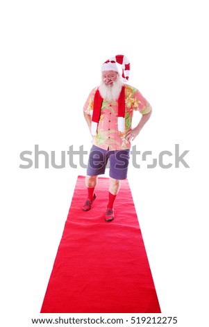 Hipster Santa Claus walks the Red Carpet in his Fashion Red Carpet Photo Shoot. Isolated on white with room for your text.
