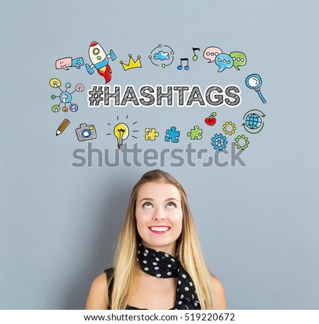 Hashtags concept with happy young woman on a gray background