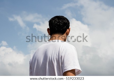 Man standing on blue sky with clouds background,Success concept with thoughtful,Risk assessment
