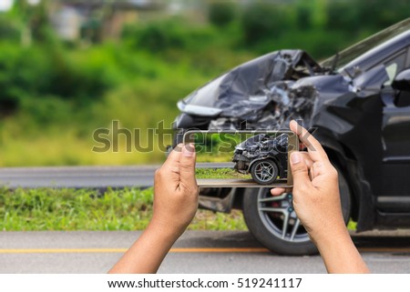 Close up hand of woman holding smartphone and take photo of car accident