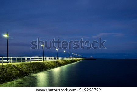 Nigh-time Reflections of a pier Royalty-Free Stock Photo #519258799
