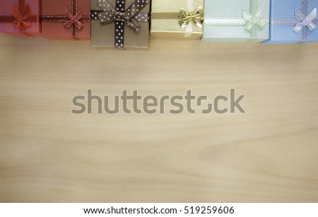 Present boxes on wooden background holidays concept.