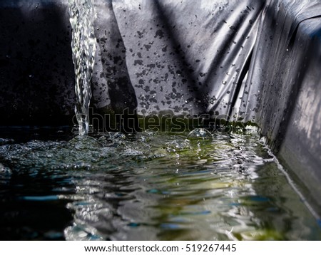 Waterfall in fish pond after thorough water filter