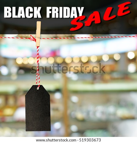 Black friday. Black sale tag on the background of shopping mall interior, shallow depth of focus