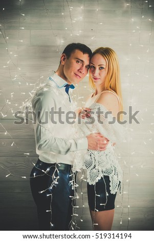 loving couple on a background garlands of lights