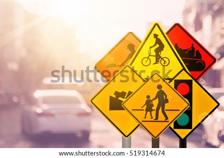 Set of traffic warning sign on blur traffic road with colorful bokeh light abstract background. Copy space of transportation and travel concept. Retro tone filter color style.