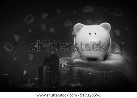 Piggy bank in the hands of the background of the city at night, the concept of business finance.