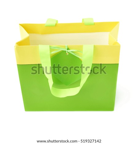 Green shopping or gift bag with label isolated over the white background