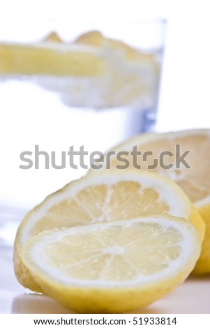 Lemon fruits with glass isolated on white