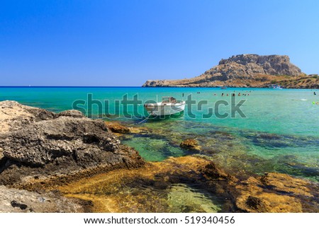 The stony beach at Rhodes Charaki, golden sand Royalty-Free Stock Photo #519340456