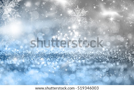 Magic blue holiday abstract glitter background with blinking stars and falling snowflakes. Blurred bokeh of Christmas lights.