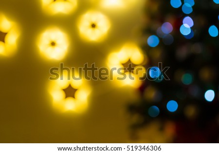 Closeup of Christmas-tree background in the living room of the house with glowing stars on the wall