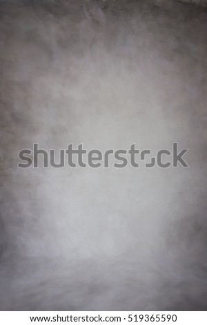 Painted canvas or muslin cotton fabric cloth studio backdrop or background, suitable for use with portraits, products and concepts. Dark brown painted design, with darker edges.  Royalty-Free Stock Photo #519365590