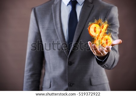 Businessman with percent sign in high interest concept