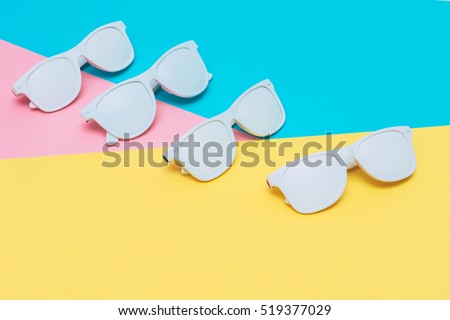 fashion sunglasses in white color on neon vibrant background. hipster style.