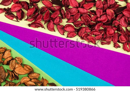 Dry petals of red rose frame background, color decorative paper card and leaves