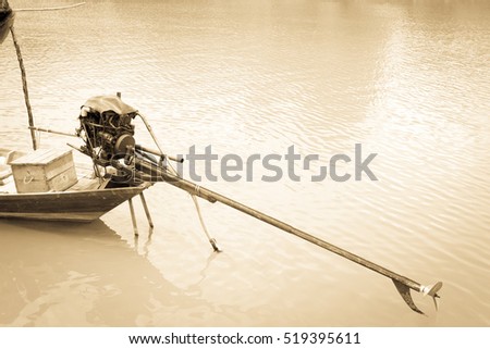 Boat tiller on water