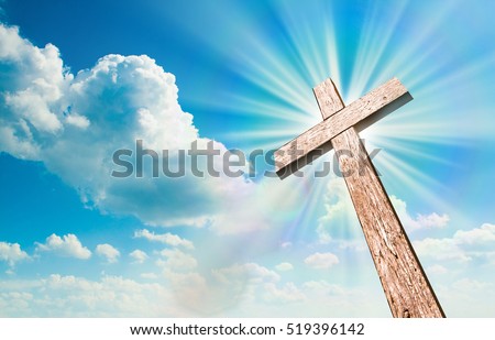 Wood cross on blue sky. Christian background.