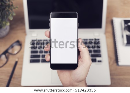 hand holding smartphone Royalty-Free Stock Photo #519423355