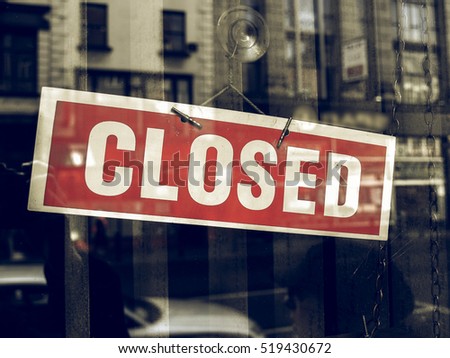 Vintage looking Closed sign in a shop showroom with reflections Royalty-Free Stock Photo #519430672