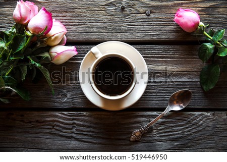 cup of coffee with red rose and and copy space on wood background. breakfast on Mothers day, Women's day, valentine's day or birth day. hot drink, flowers