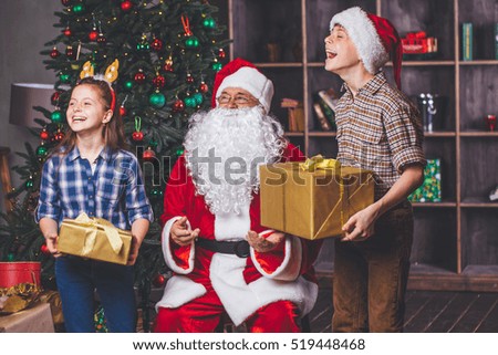 Christmas. Children are happy to receive gifts from Santa. Children and santa claus