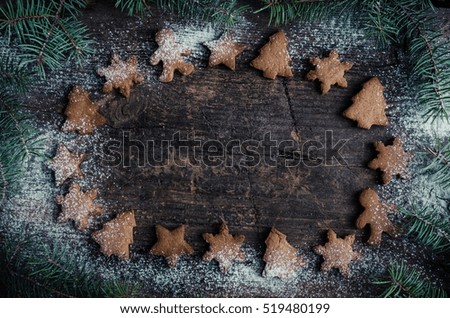 Christmas fir tree with homemade gingerbread cookies on old wooden background with space for text. Merry Christmas and Happy New Year. Xmas background. Christmas concept. Top view. Copy space.