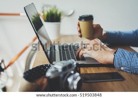 Professional manager using modern laptop while working at new office, male freelancer working from home or coffee shop via portable computer, businessman reading email on portable computer