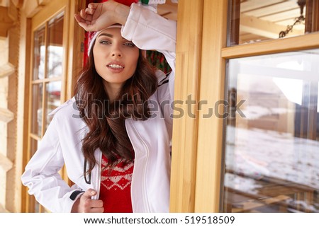 woman resting after a winter sports on the terrace of the resort house